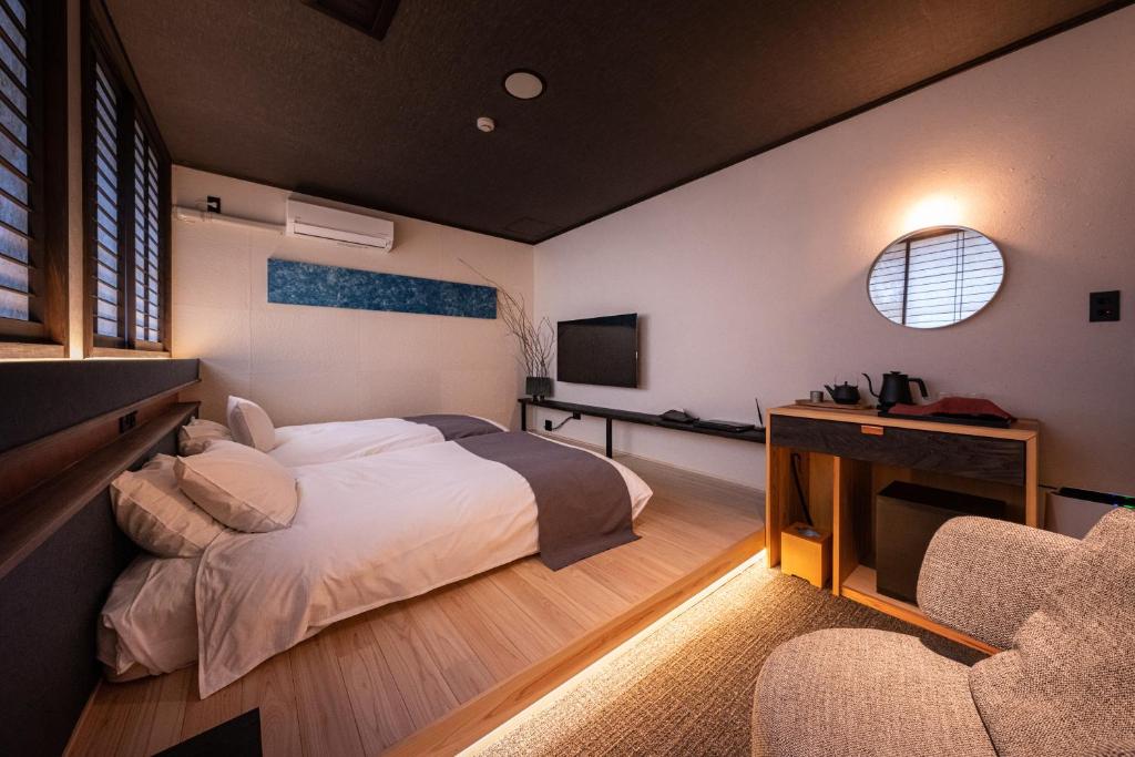 Postel nebo postele na pokoji v ubytování Ryokan Nushiya