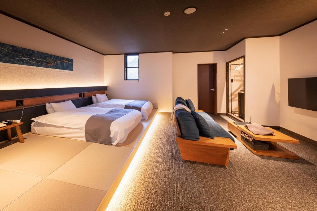 Postel nebo postele na pokoji v ubytování Ryokan Nushiya
