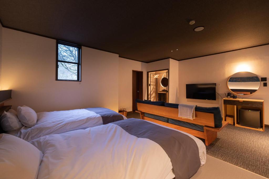 Postel nebo postele na pokoji v ubytování Ryokan Nushiya
