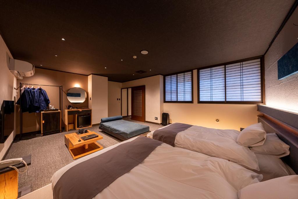Postel nebo postele na pokoji v ubytování Ryokan Nushiya