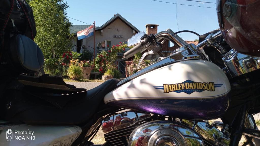 a close up of a motorcycle parked on the street at Apartment Ada bed & breakfast in Gračac