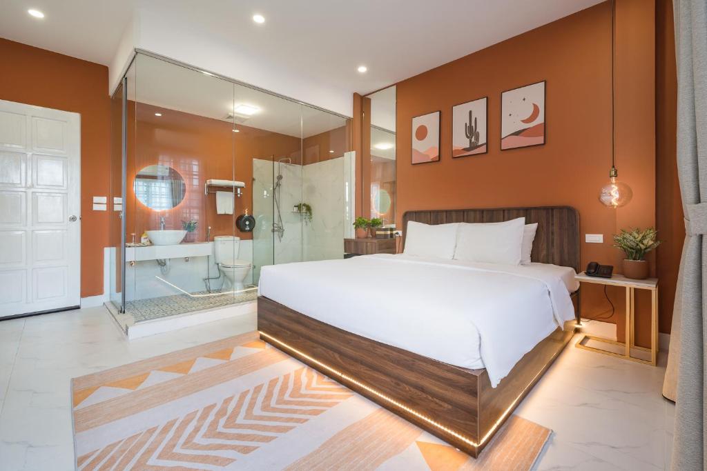 a bedroom with a large white bed and a shower at C o r o n a Hanoi House in Hanoi