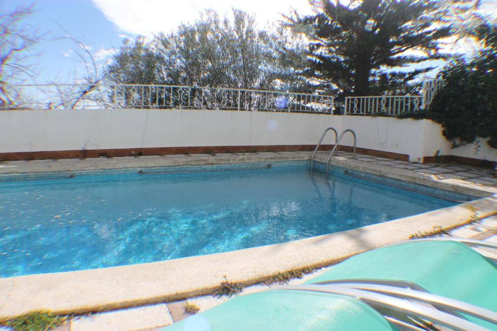 a swimming pool in a yard with a fence at Agi Villa Cibeles in Roses