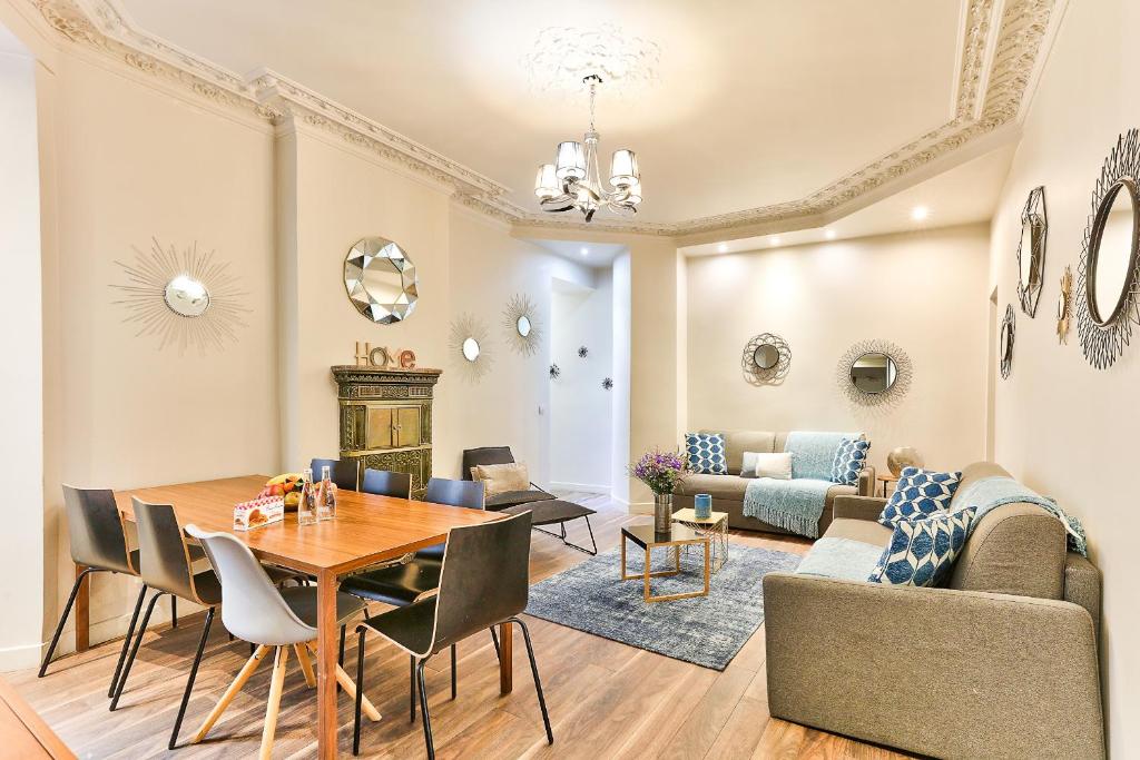 une salle à manger et un salon avec une table et des chaises dans l'établissement 57-LUXURY PARISIEN HOME SEBASTOPOL 1 (2G), à Paris