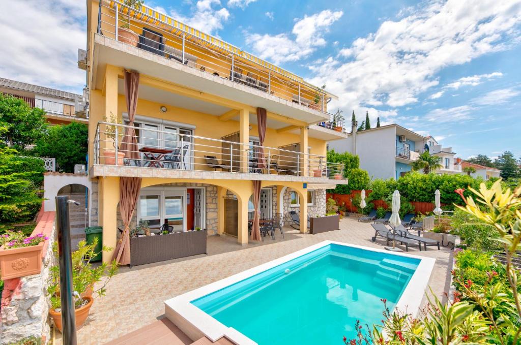 an exterior view of a house with a swimming pool at NOVOSELIC 7 Penthaus in Dramalj