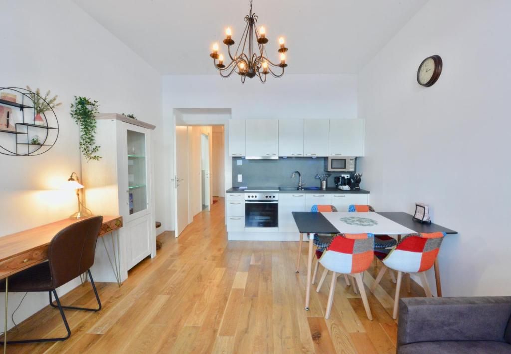 a kitchen and dining room with a table and chairs at L&G's Apartment - Balcony - Close to Car Park in Vienna