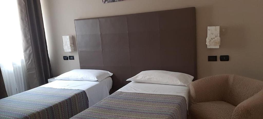 Postel nebo postele na pokoji v ubytování Da Gianni Hotel
