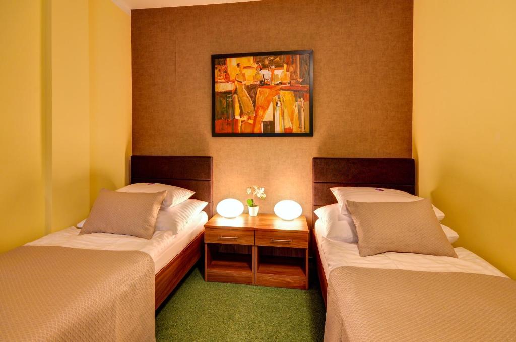 Postel nebo postele na pokoji v ubytování Hotel Hermes