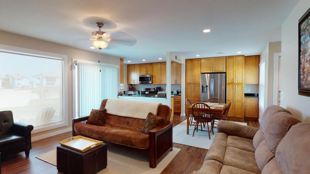 a living room with a couch and a kitchen at AH-B107 Completely Remodeled Ground Floor Condo, Overlooking PoolHot Tub in Port Aransas