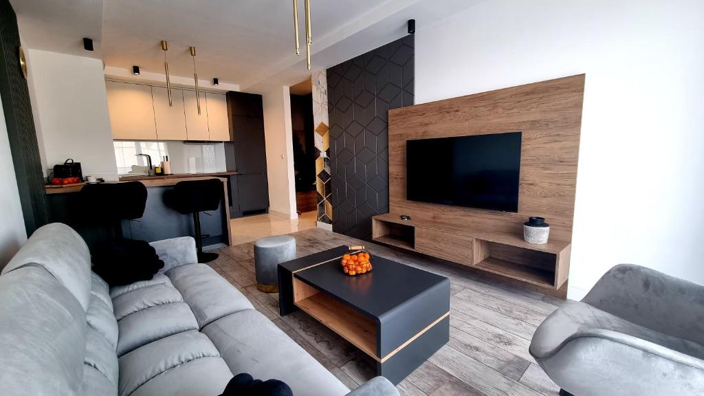 Televízia a/alebo spoločenská miestnosť v ubytovaní NOOK NOOK Apartments Bytkowska 103