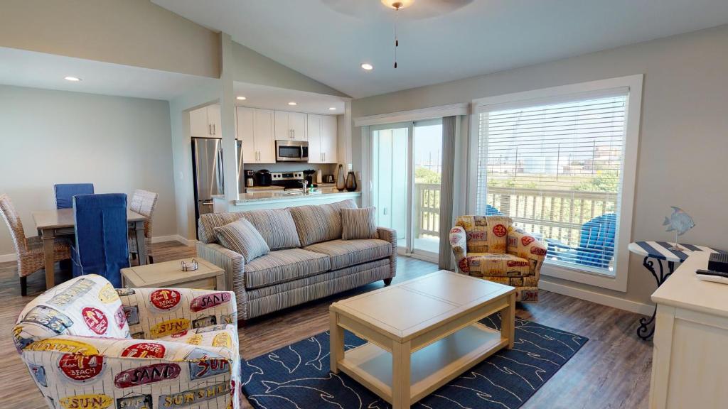 a living room with a couch and a table at AH-K239 Newly Remodeled Second Floor Condo With Bay View, Shared Pool in Port Aransas