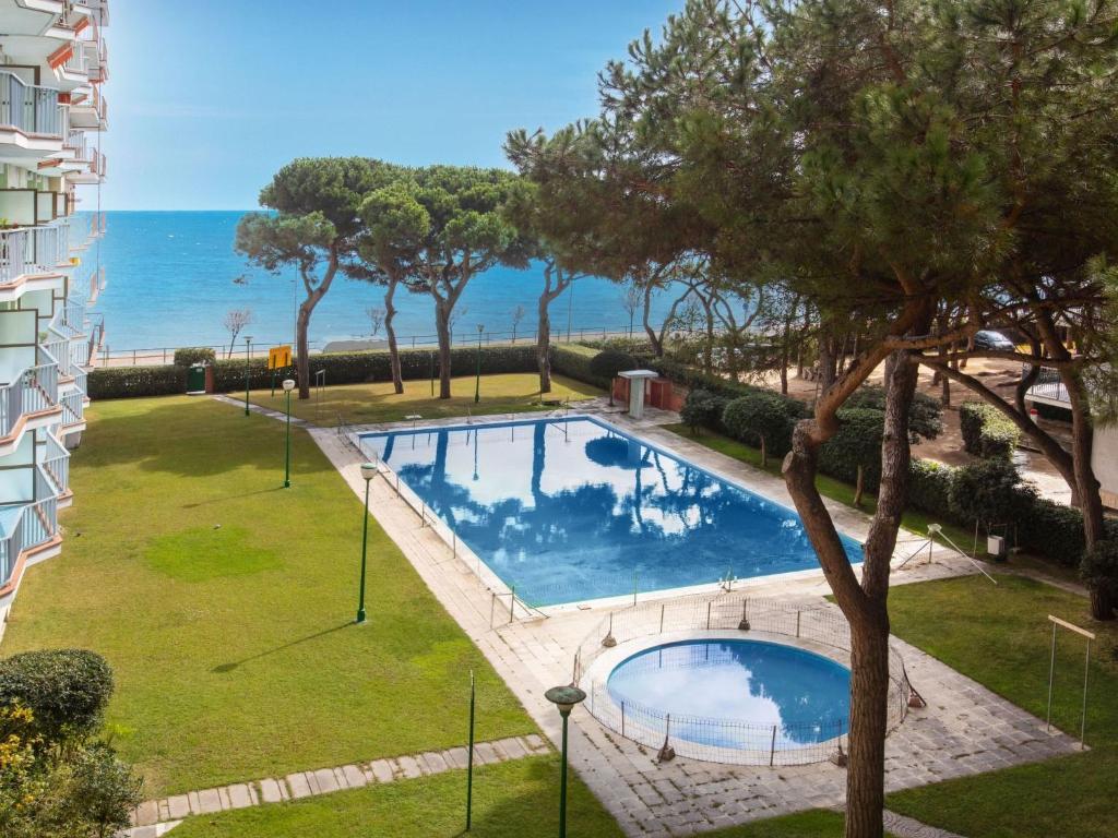 a swimming pool with a view of the ocean at Apartment Olivier by Interhome in Blanes