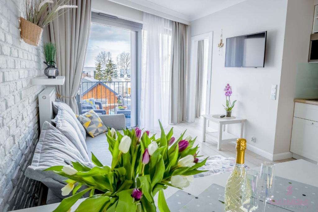 Televízia a/alebo spoločenská miestnosť v ubytovaní Your Holidays Horyzont