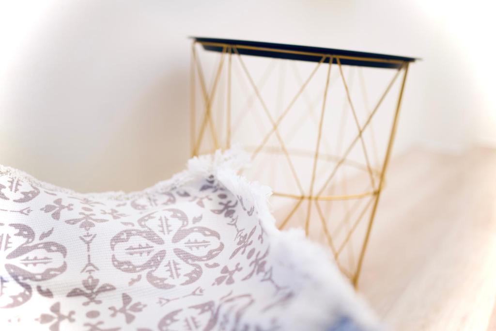 a black and gold stand with a white pillow at It's Mine Hostel in Taitung City