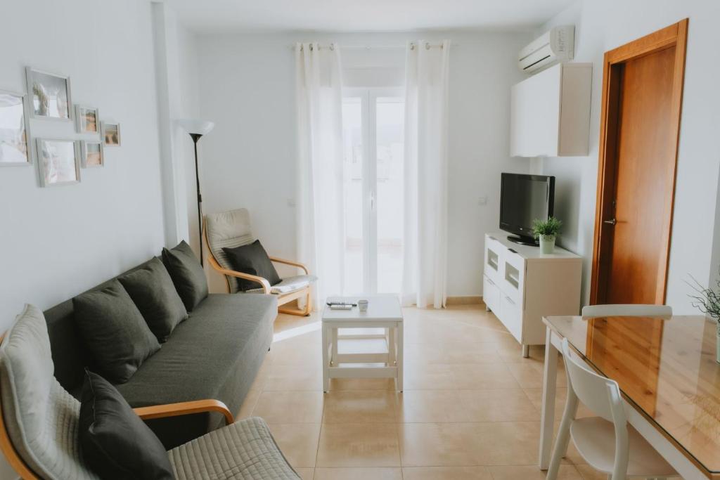 a living room with a couch and a table at Apartamentos ZHR 1 in Zahara de los Atunes