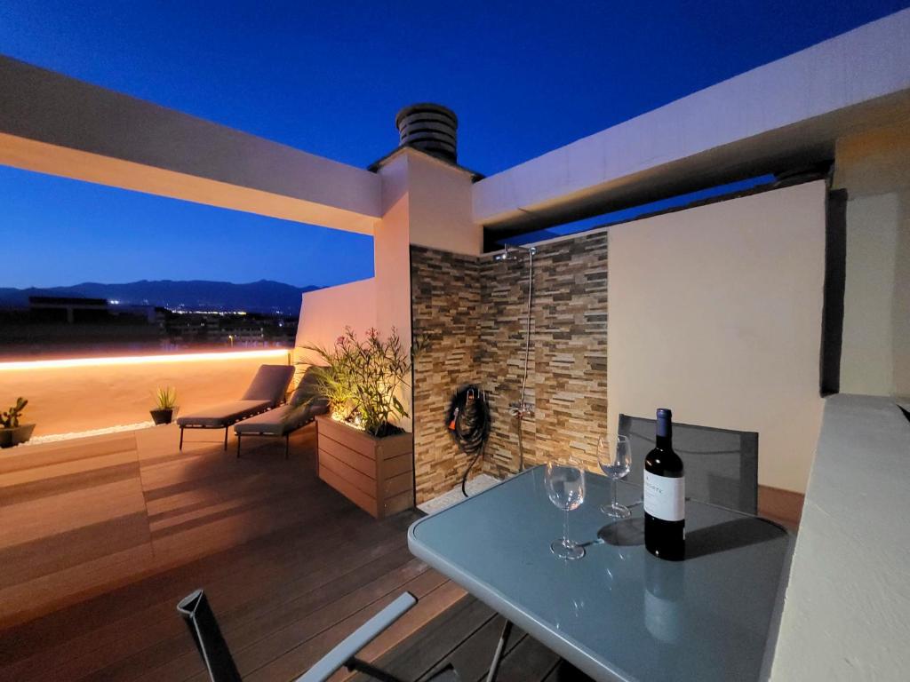 a bottle of wine sitting on a table on a patio at MEDANO4YOU Kevin's Penthouse in El Médano