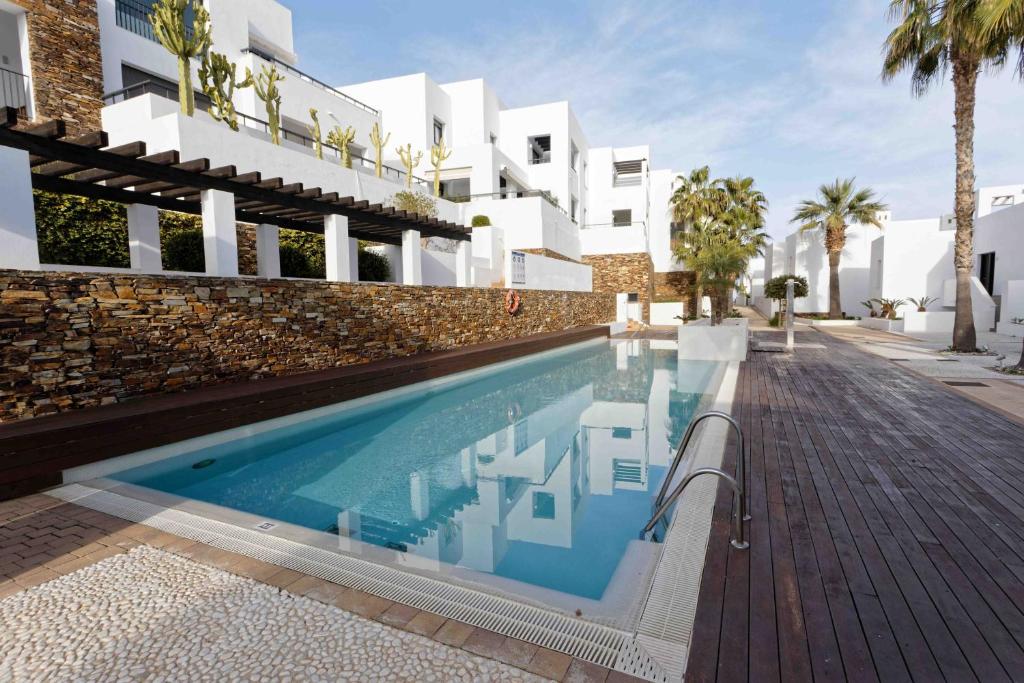 a swimming pool in front of a building at SPECTACULAR APRT. IN FRONT OF THE SEA in Mojácar