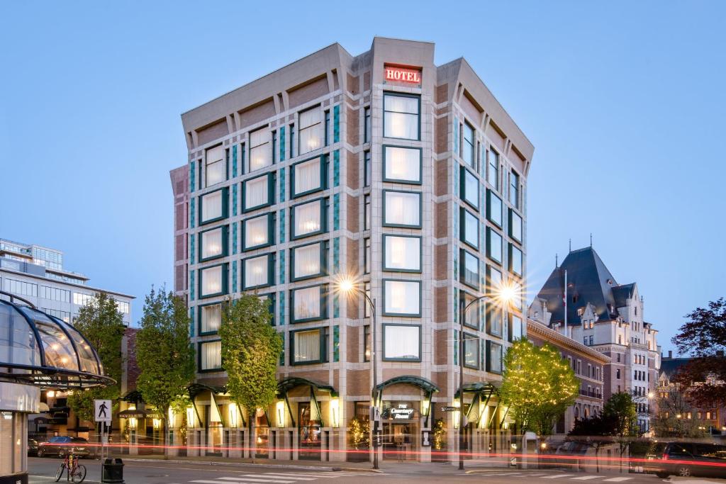 a tall building on a city street at dusk at The Magnolia Hotel & Spa in Victoria