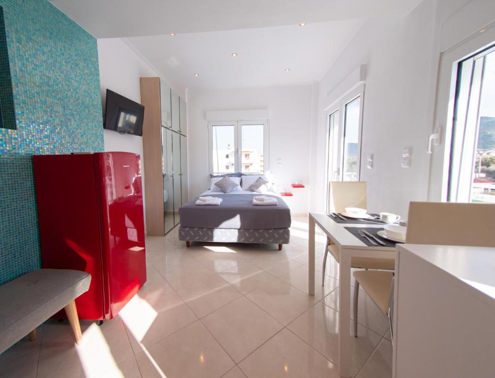 a bedroom with a bed and a desk in a room at Lux Sea Studio - Porto Rafti in Porto Rafti