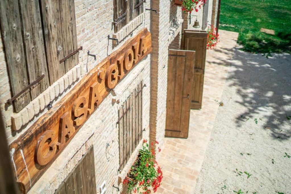 ein Schild an der Seite eines Backsteingebäudes in der Unterkunft Casa Gioia in Brigolo