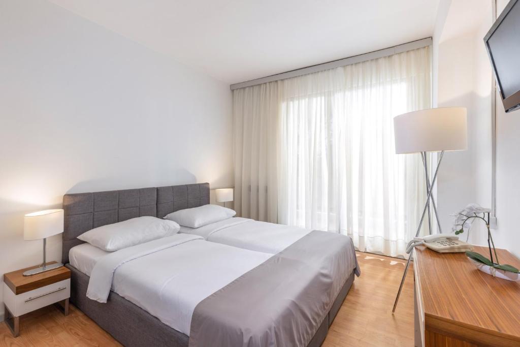 Postel nebo postele na pokoji v ubytování Hotel Zagreb
