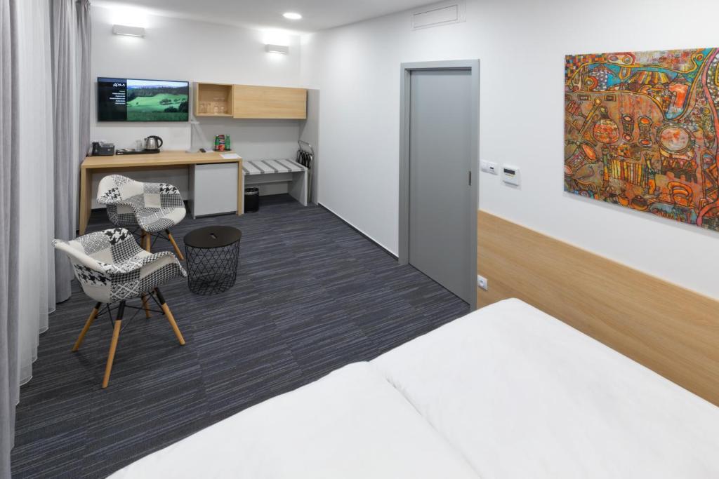 Postel nebo postele na pokoji v ubytování Ala hotel