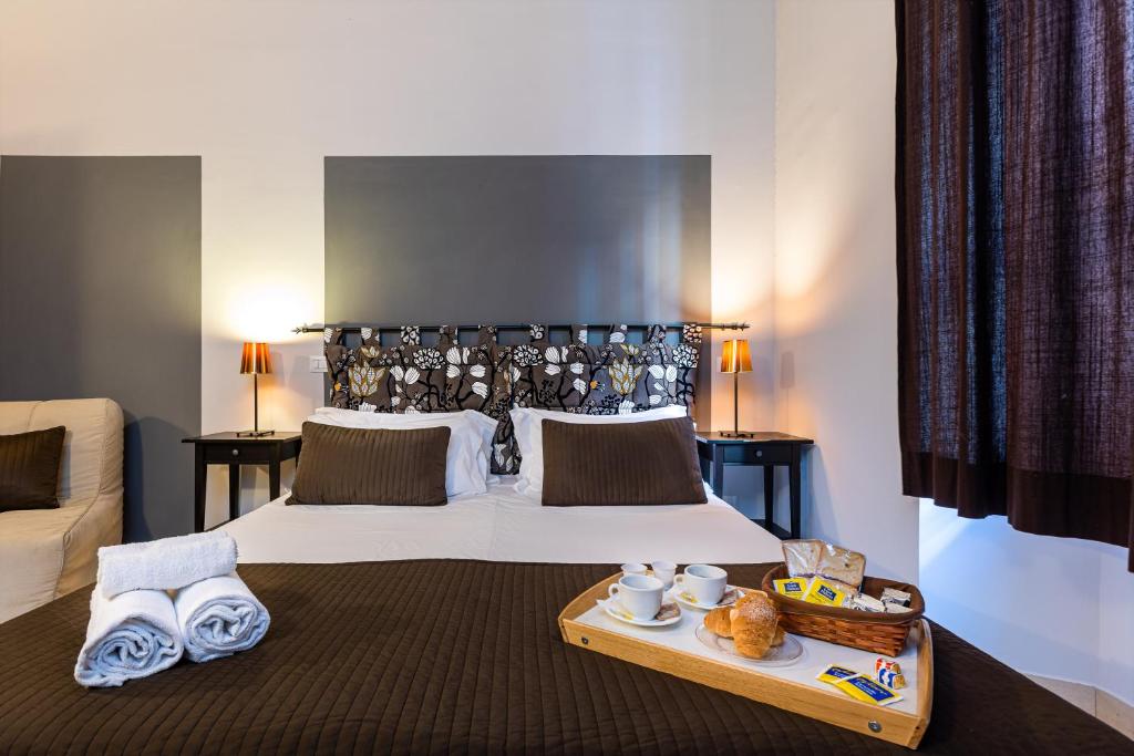 Łóżko lub łóżka w pokoju w obiekcie San Lorenzo Rooms