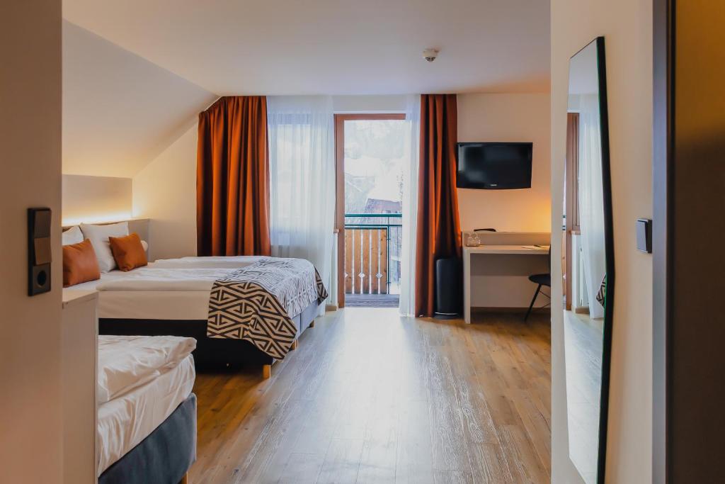 Postel nebo postele na pokoji v ubytování Hotel Alpenblick Kreischberg