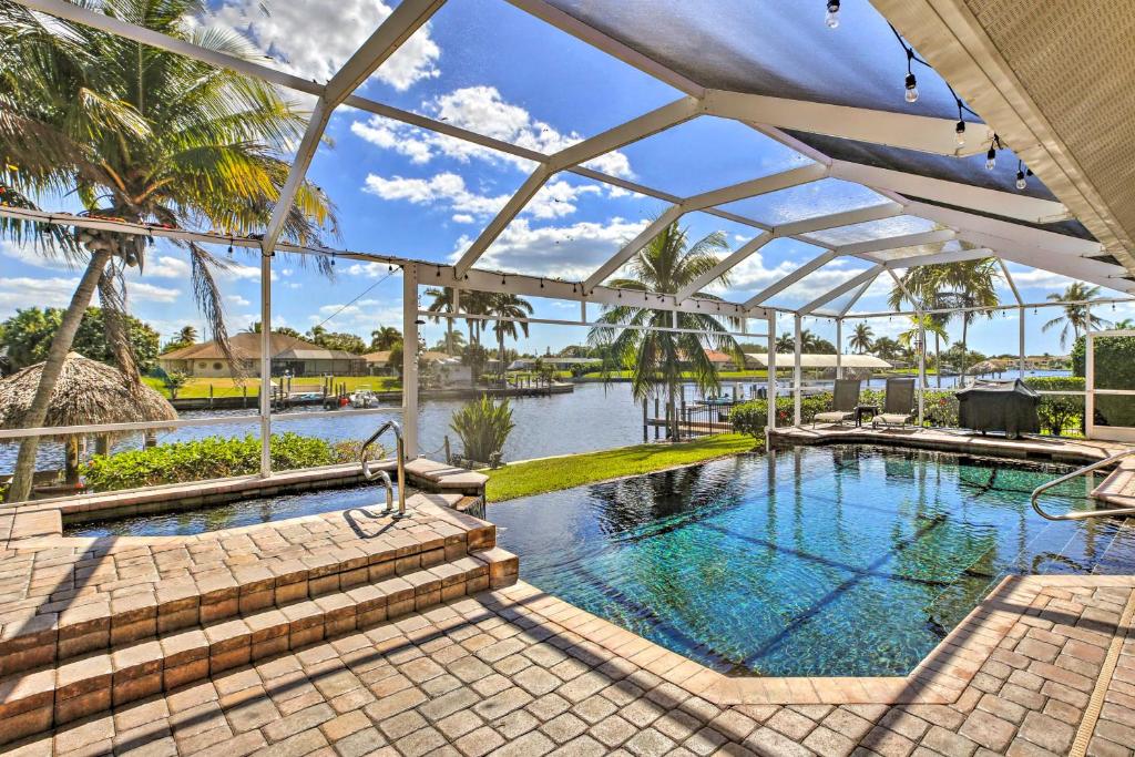 an indoor swimming pool with a resortiterranean style house at Waterfront Pool and Spa Relaxing Cape Coral Retreat in Cape Coral