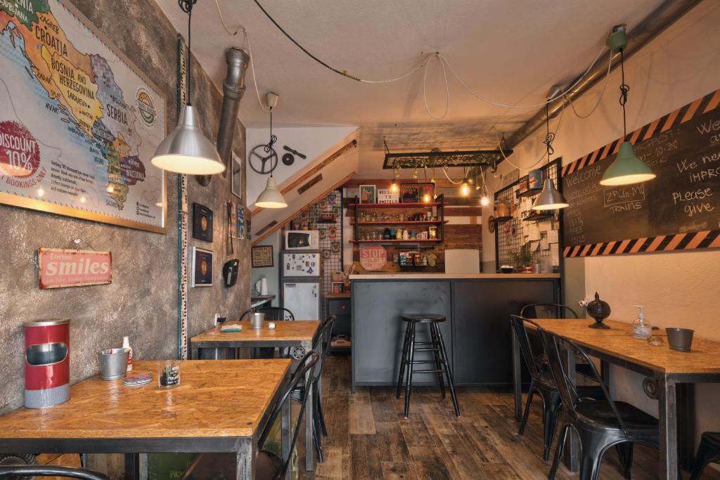 a restaurant with wooden tables and a bar at Q PODGORICA Beds,Rooms and more in Podgorica