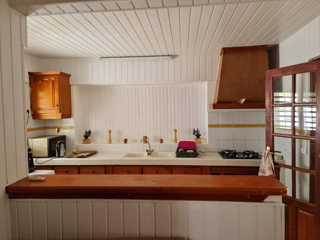 a kitchen with a sink and a counter top at Maison CORVO in Gourbeyre
