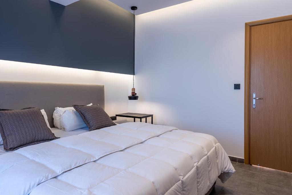 a bedroom with a large white bed with two pillows at Cirillo Family Hotel-Christinas Studios in Mastihari