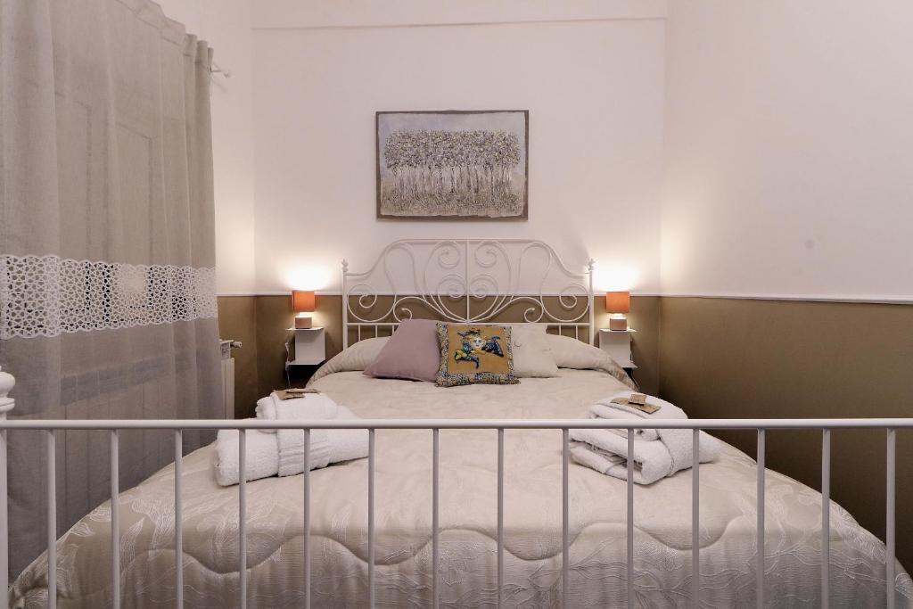 a bedroom with a white bed with a metal frame at CentroCittà Comfort in Catania