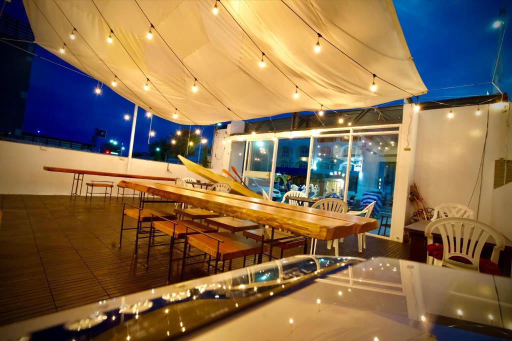 a patio with a table and chairs and lights at It's Mine Hostel in Taitung City