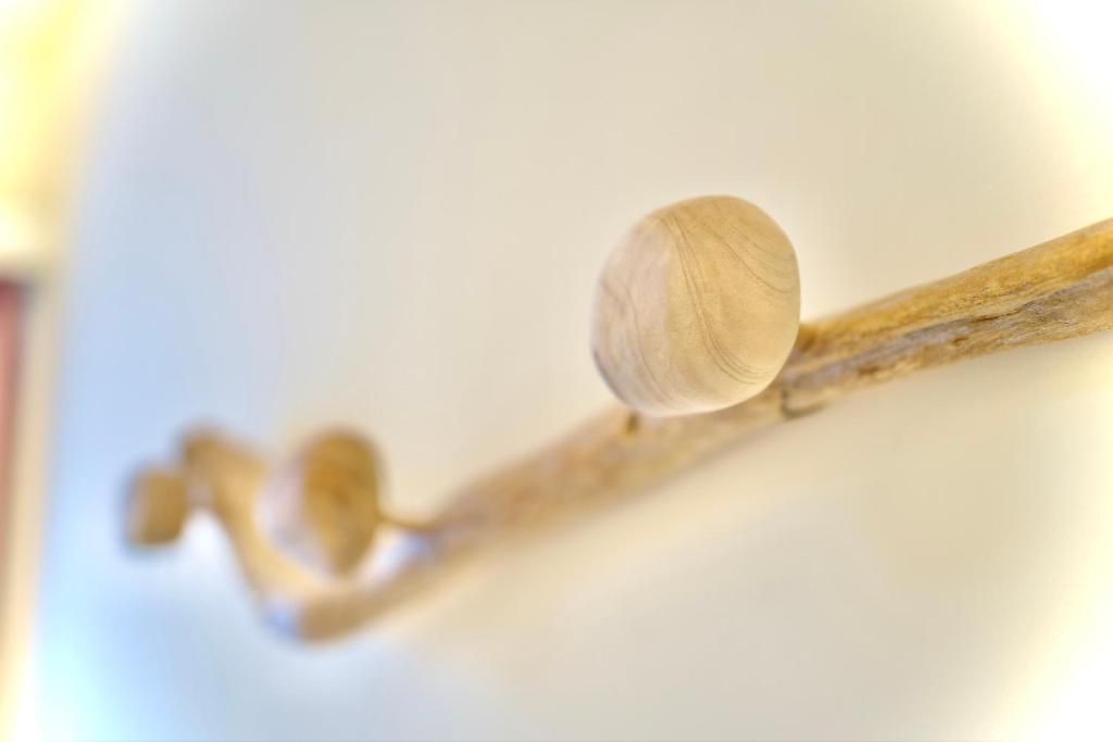 a wooden spoon on a wooden stick on a wall at It's Mine Hostel in Taitung City