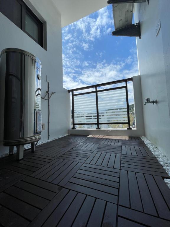 a large room with a large window and a large floor at It's Mine Hostel in Taitung City