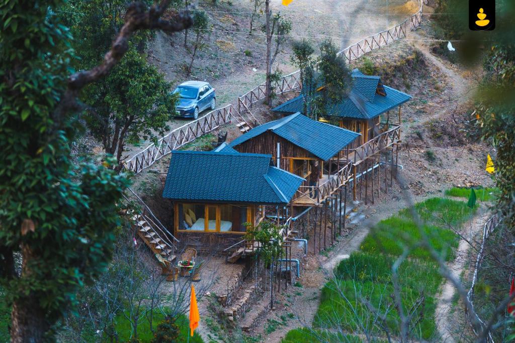 an overhead view of a house with a blue roof at LivingStone Shimla Jungle Stay in Shimla