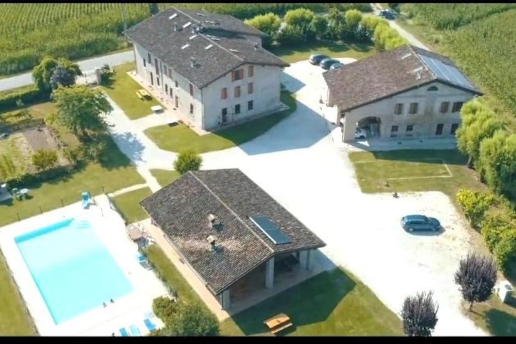 an aerial view of a large house with a swimming pool at La Garzaga Turismo Rurale in Ceresara