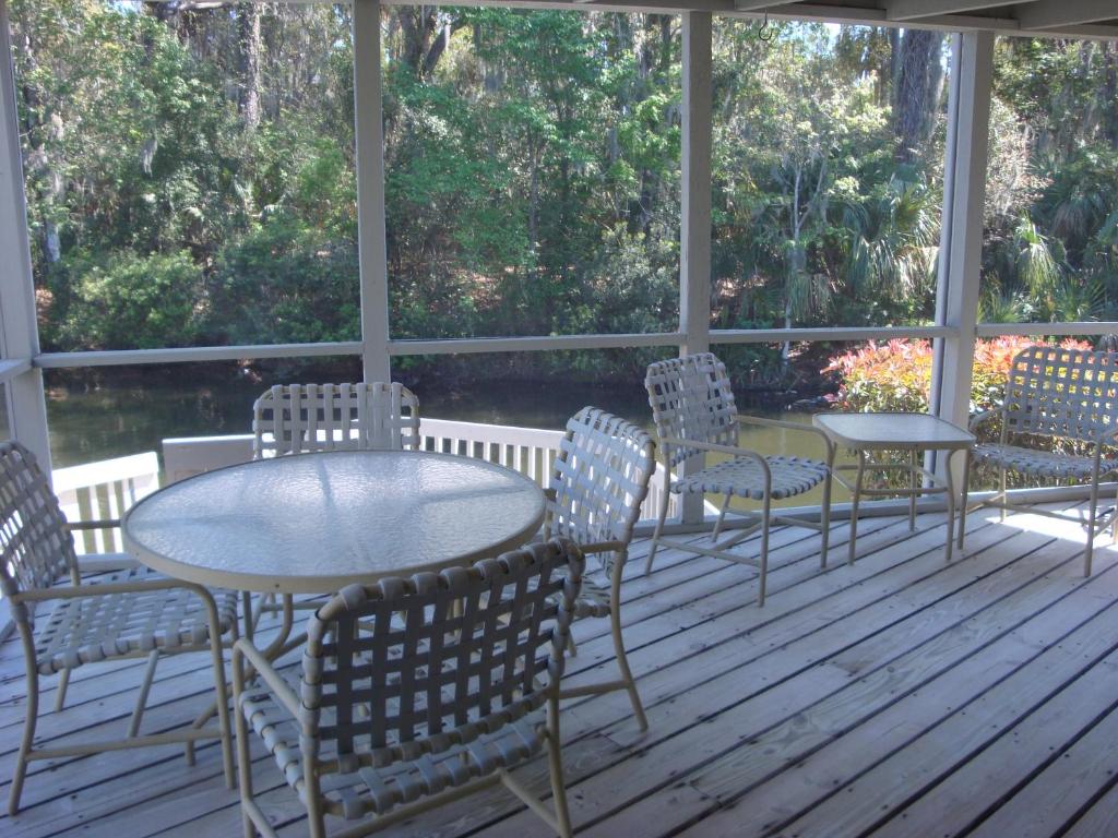 a porch with a table and chairs on a deck at Ponte Vedra Players Club Villa 17, Players Club Pool, 3 Bedrooms, Sleeps 6 in Ponte Vedra