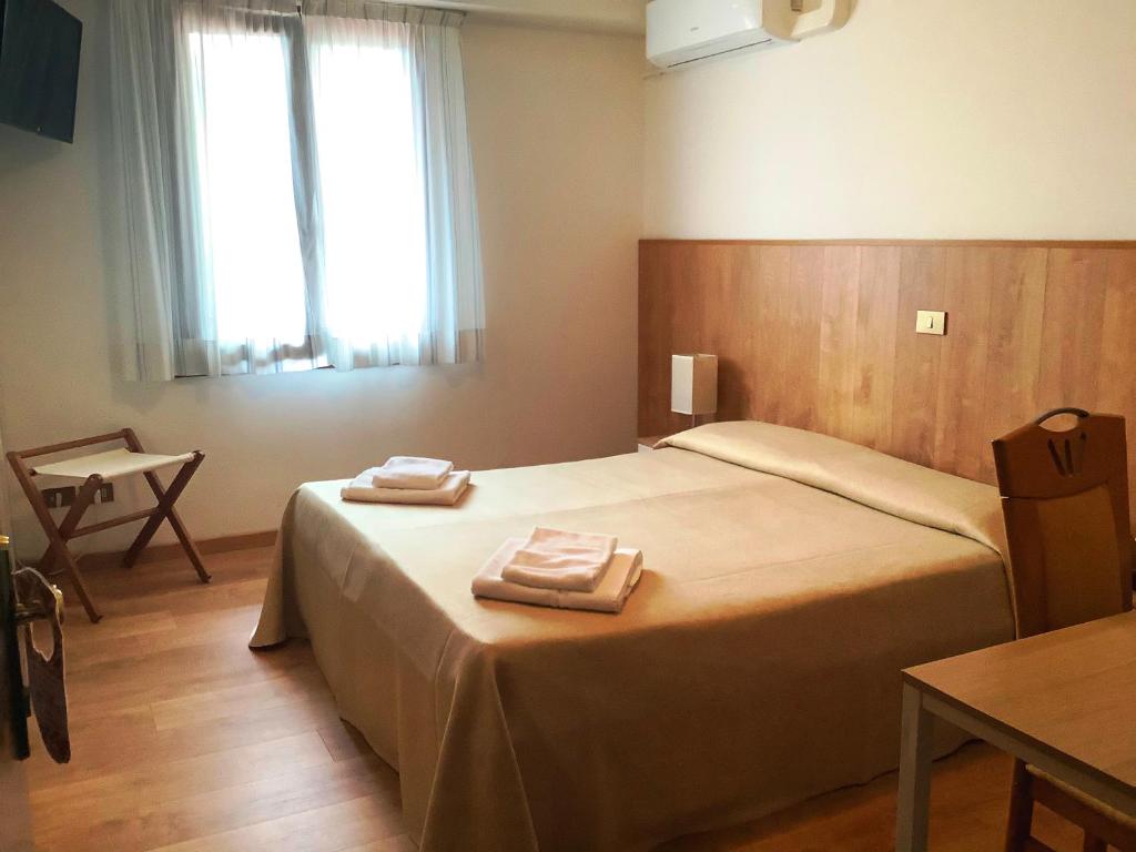 Postel nebo postele na pokoji v ubytování Hotel Al Posta