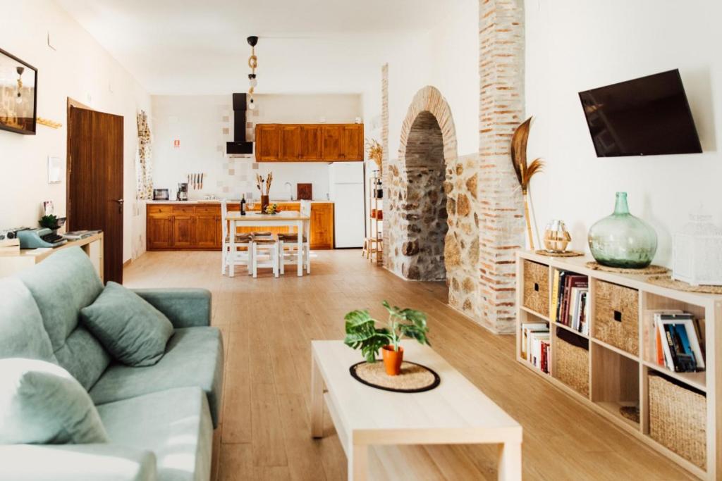 a living room with a couch and a table at CASA RURAL LA VEGUILLA in Fuente del Arco