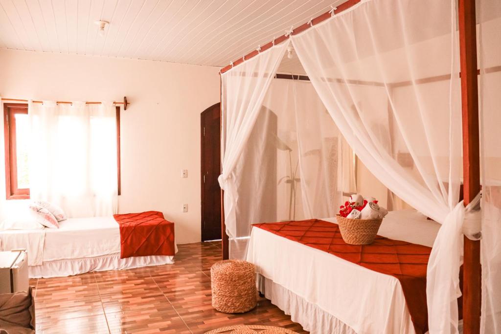 a bedroom with two beds and a window at Prana Eco Villa in Atins