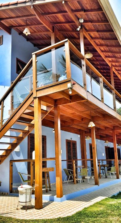 a house with a large deck with a balcony at Pousada Villa Maritima in Trindade
