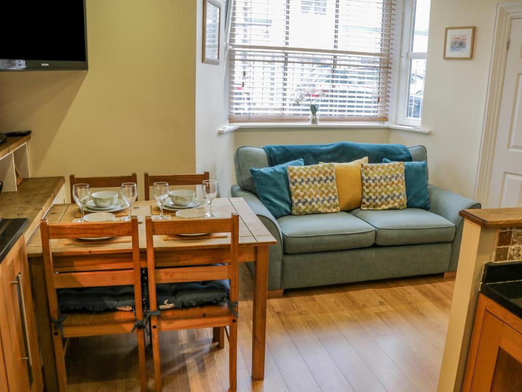 een woonkamer met een bank en een tafel bij Apartment 6 in Whitby