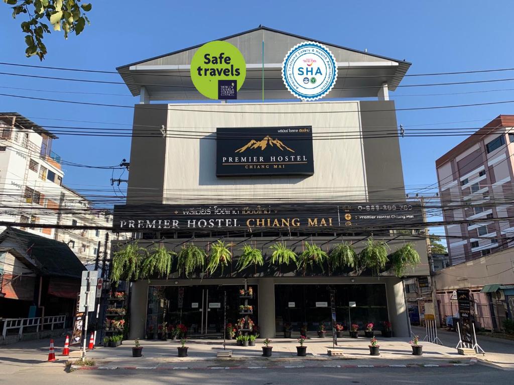 a building with a sign on the top of it at Premier Hostel Chiang Mai in Chiang Mai