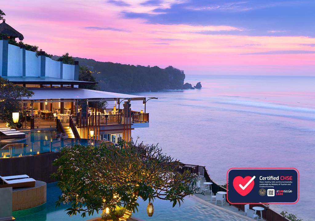 
a view from a boat of a beach with a view of the ocean at Anantara Uluwatu Bali Resort in Uluwatu
