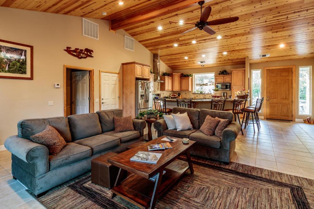 a living room with couches and a table at Murray Lake Retreat in Bass Lake