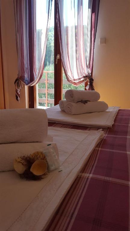 a room with two beds with towels and a window at Apartment Ana in Kali