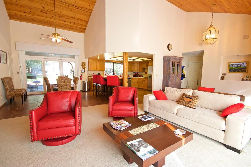 a living room with a white couch and red chairs at Yosemite Nutter Ranch in Mariposa