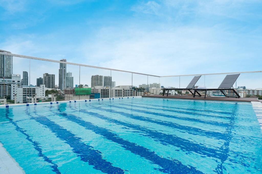 a large swimming pool on the roof of a building at Hotel Amber Sukhumvit 85 in Bangkok